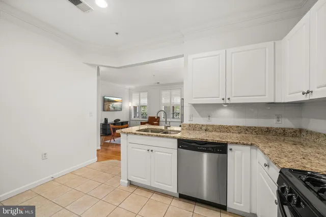 a kitchen with stainless steel appliances granite countertop a sink and cabinets
