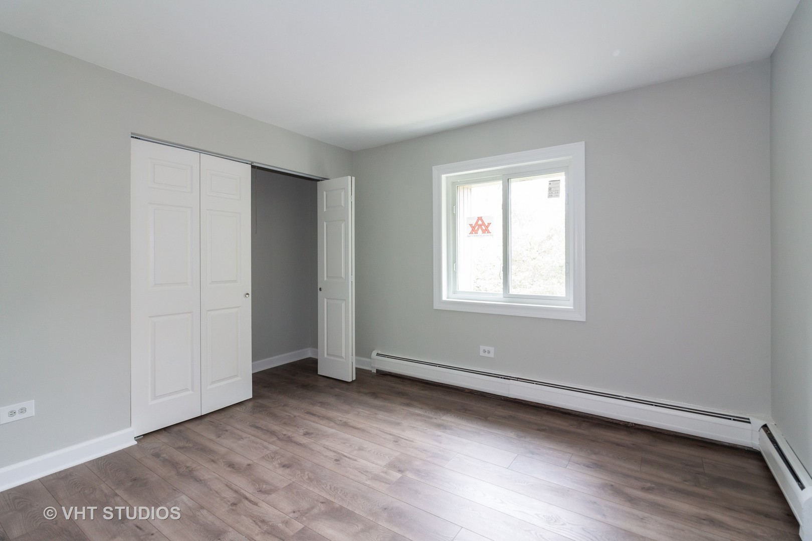 214 East Bailey Road, Unit L Naperville, IL 60565 - Photo 8 of 12 an empty room with wooden floor and windows