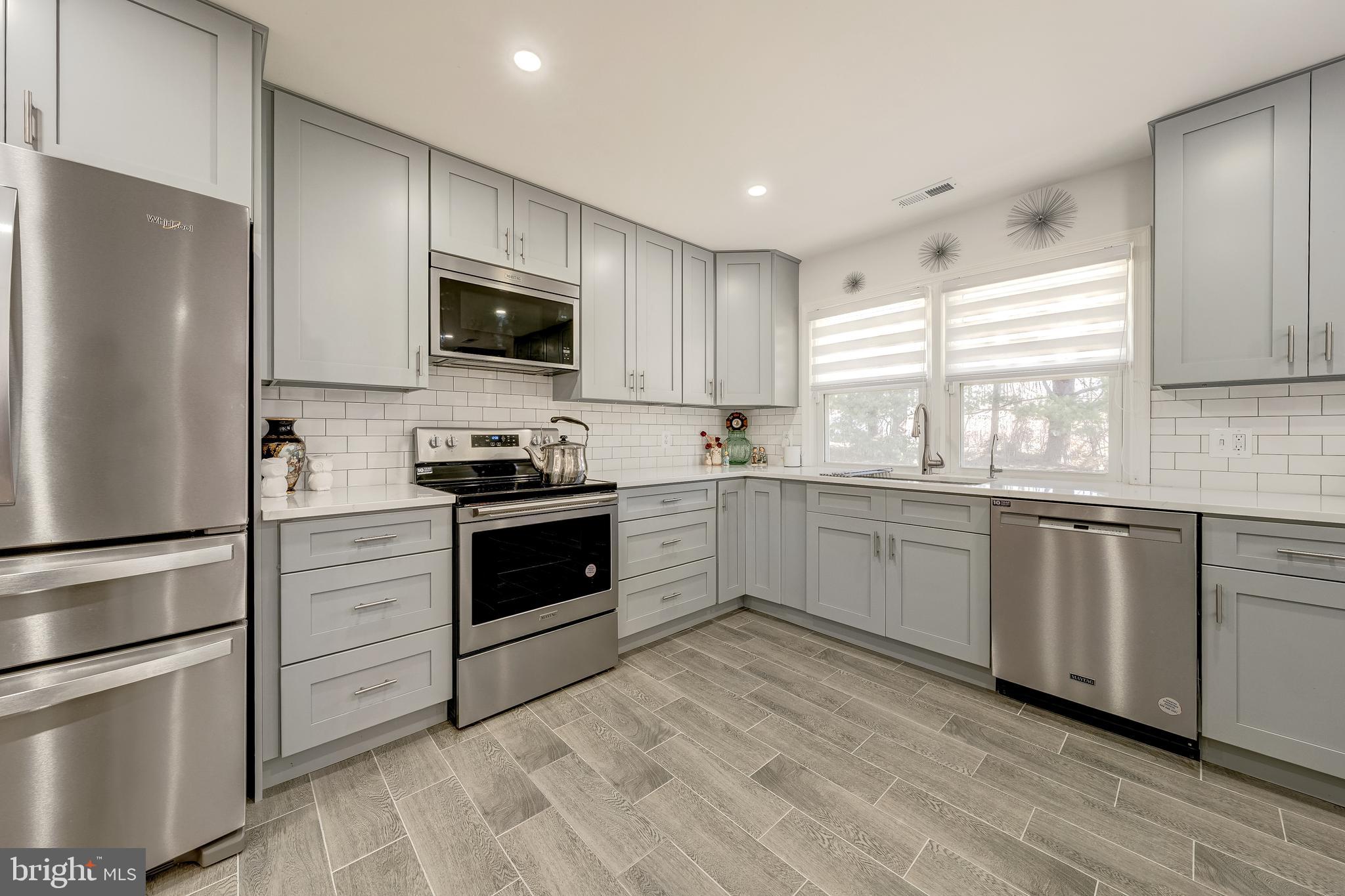 6017 Wheeler Lane Broad Run, VA 20137 - Photo 12 of 45 a kitchen with a refrigerator stove and microwave