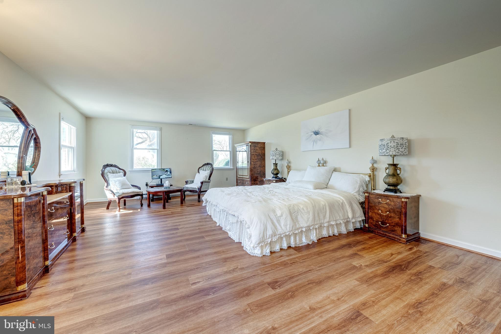 6017 Wheeler Lane Broad Run, VA 20137 - Photo 16 of 45 a spacious bedroom with a bed and wooden floor