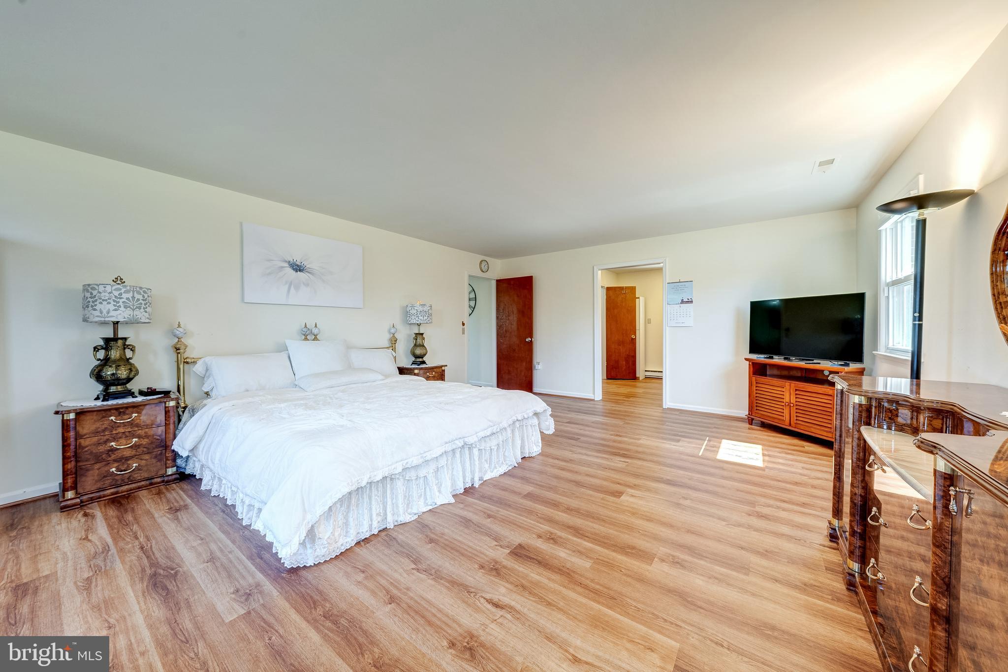 6017 Wheeler Lane Broad Run, VA 20137 - Photo 18 of 45 a bedroom with a bed and a flat screen tv