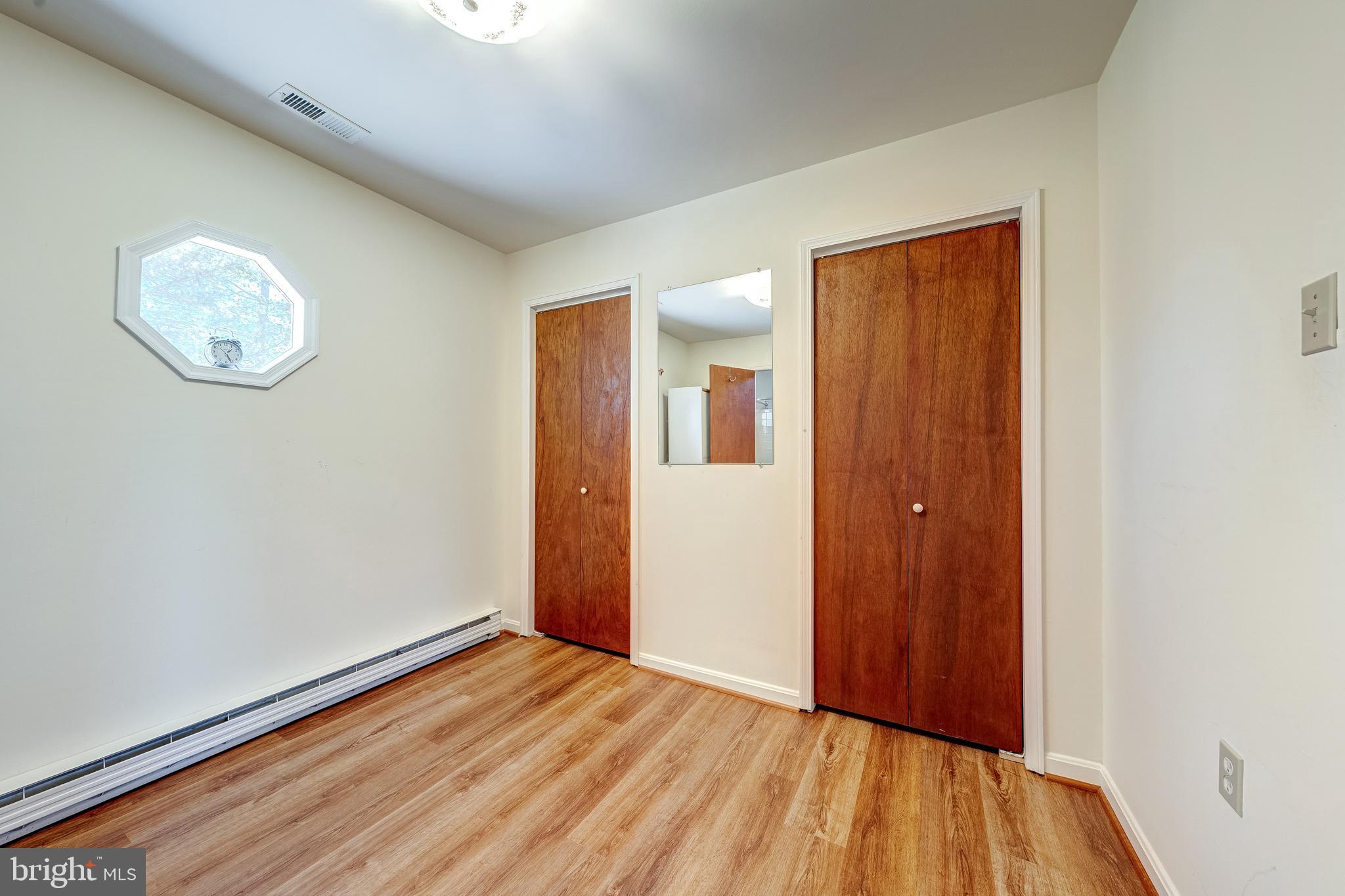 6017 Wheeler Lane Broad Run, VA 20137 - Photo 19 of 45 a view of an empty room with wooden floor and a window