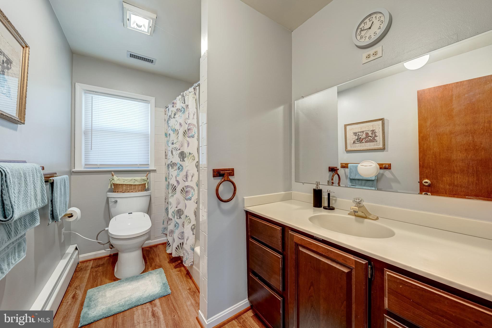 6017 Wheeler Lane Broad Run, VA 20137 - Photo 23 of 45 a bathroom with a sink toilet and a mirror