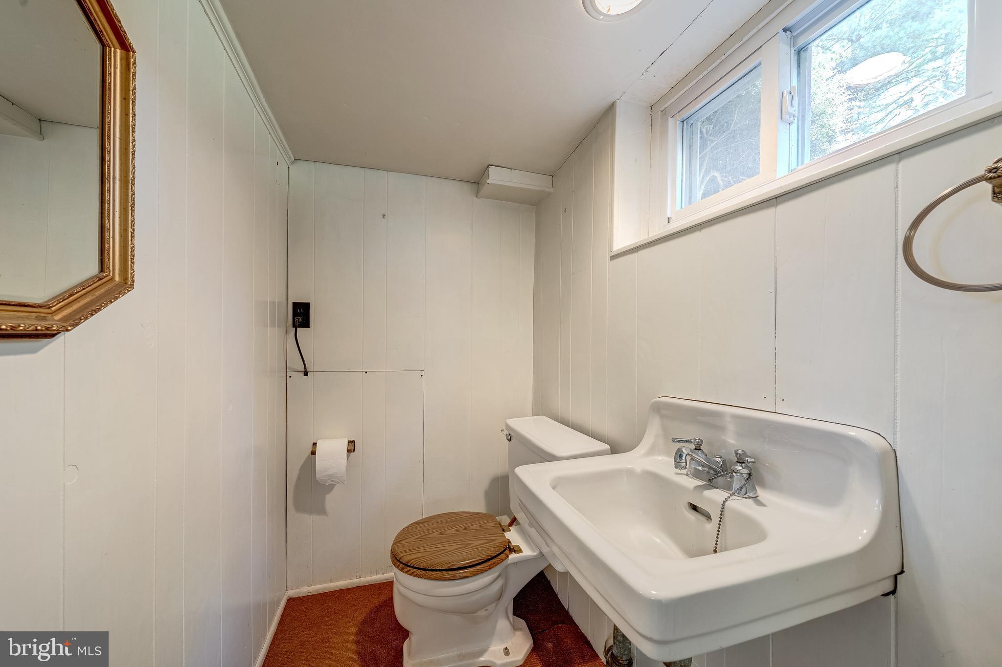 6017 Wheeler Lane Broad Run, VA 20137 - Photo 25 of 45 a bathroom with a sink toilet and a mirror