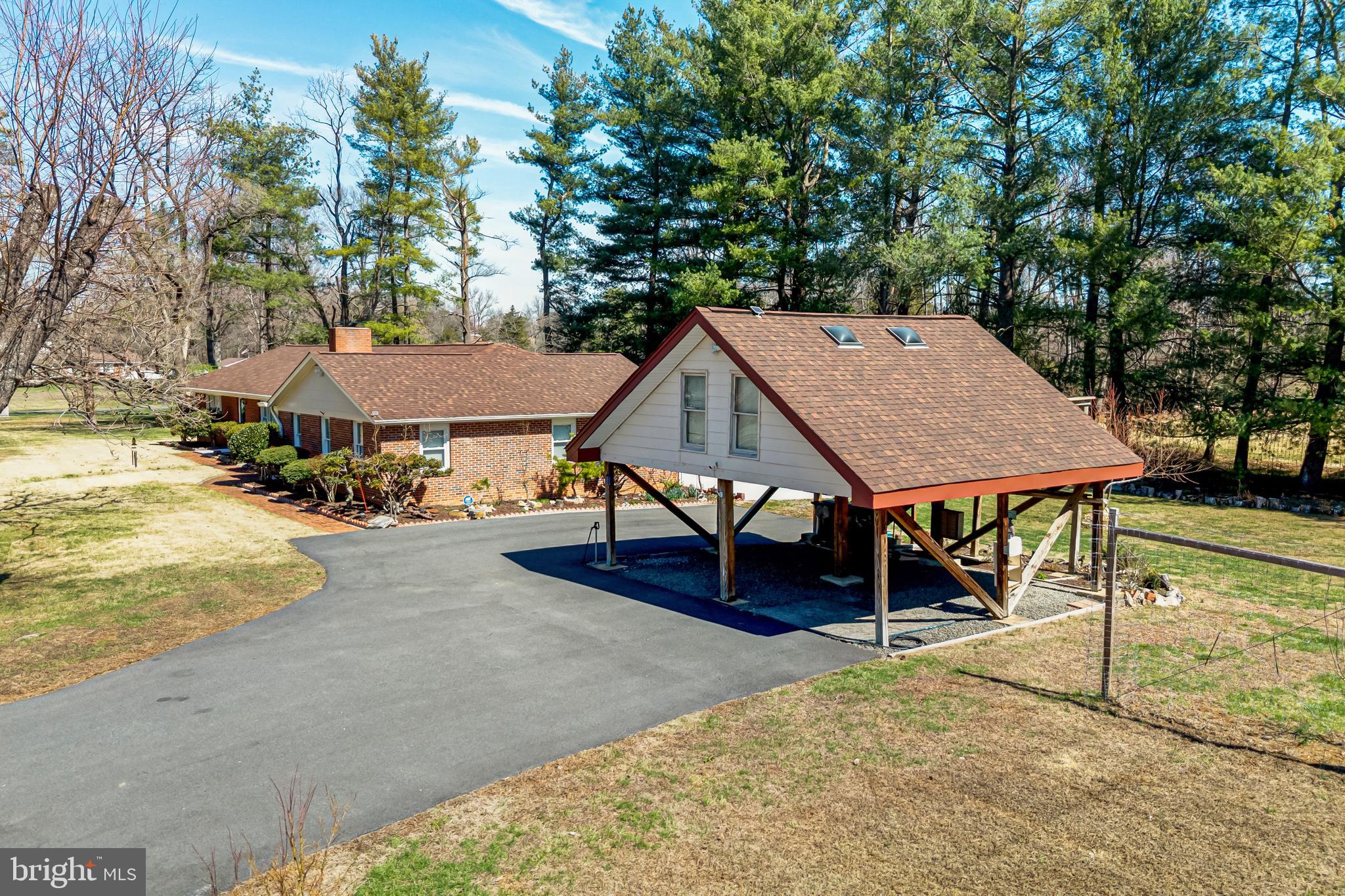 6017 Wheeler Lane Broad Run, VA 20137 - Photo 36 of 45 a view of a roof deck with table and chairs under an umbrella
