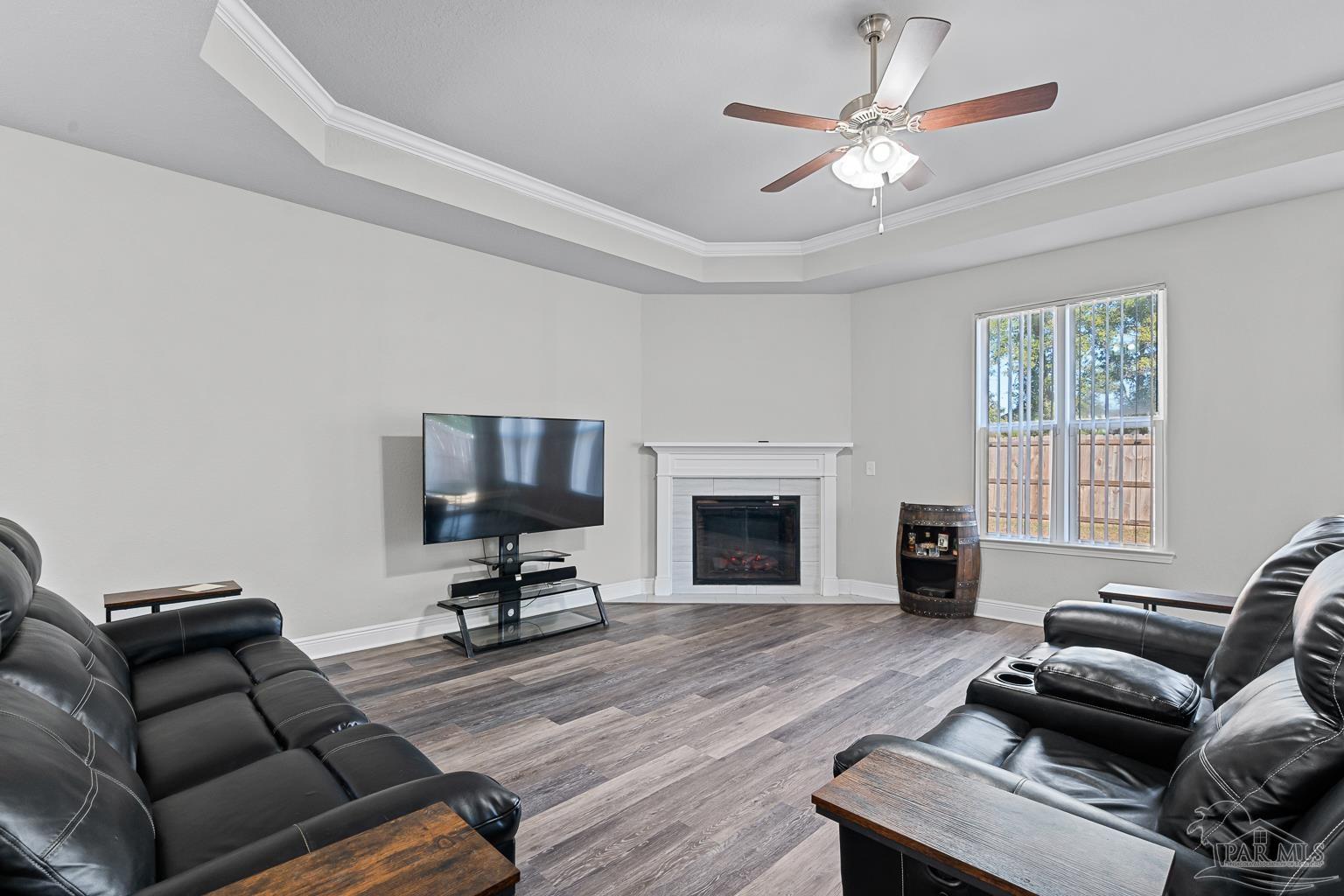 3838 Ranch Road Pace, FL 32571 - Photo 16 of 40 a living room with furniture and a fireplace