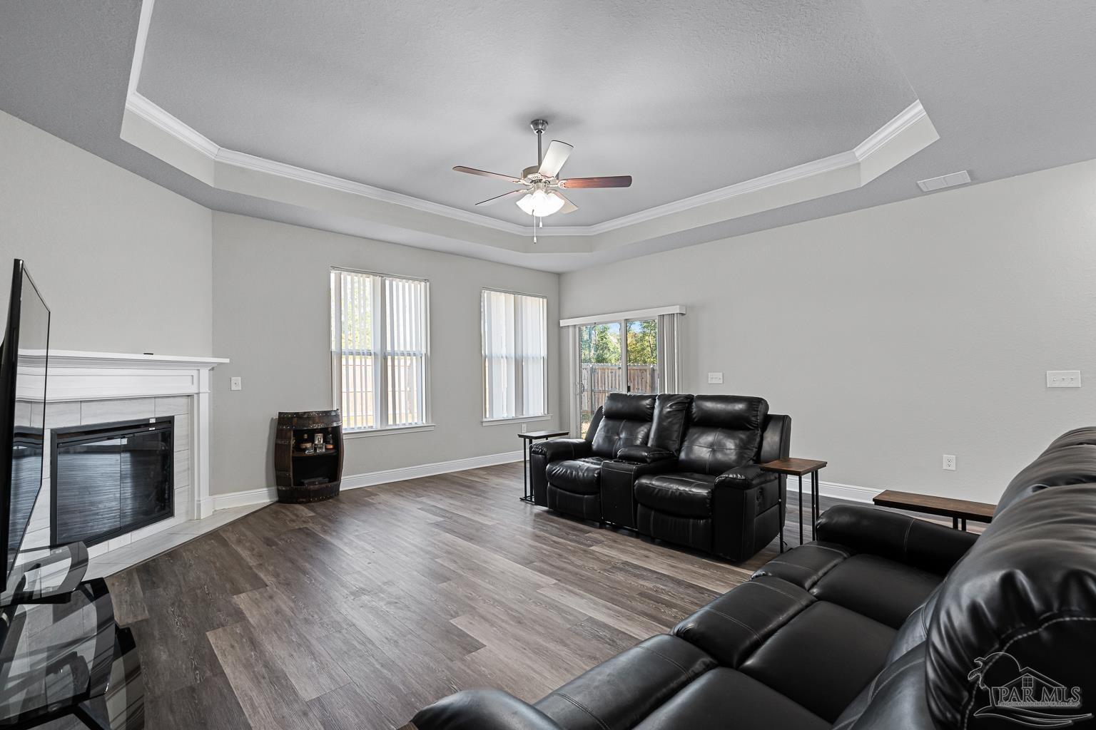 3838 Ranch Road Pace, FL 32571 - Photo 16 of 42 a living room with furniture windows and a fireplace