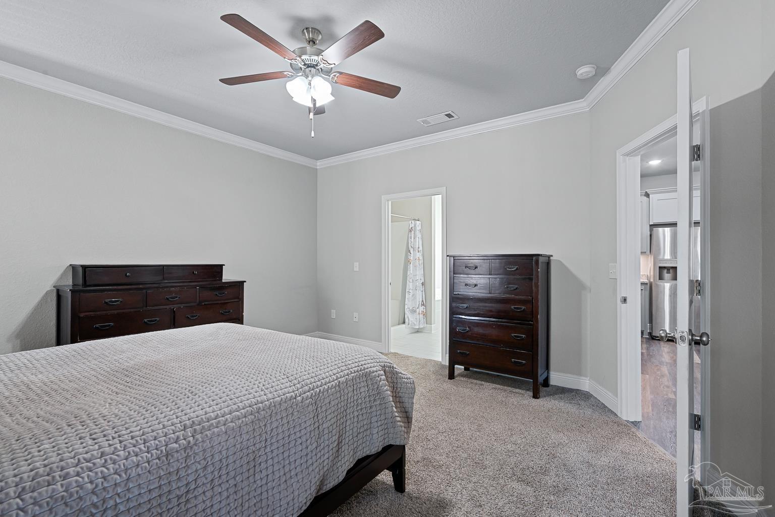 3838 Ranch Road Pace, FL 32571 - Photo 20 of 40 a bedroom with a bed and a chandelier