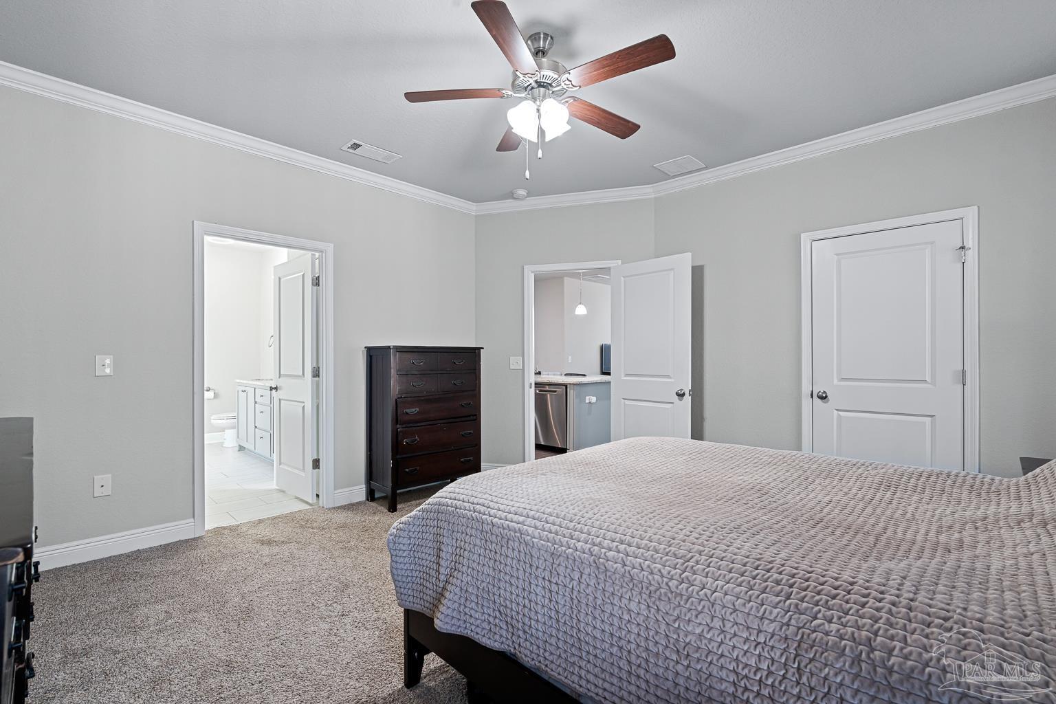 3838 Ranch Road Pace, FL 32571 - Photo 22 of 42 a large bedroom with a bed and a chandelier