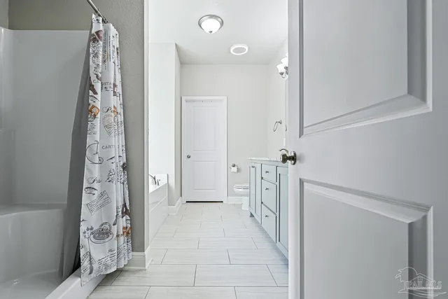 a bathroom with a bathtub and shower