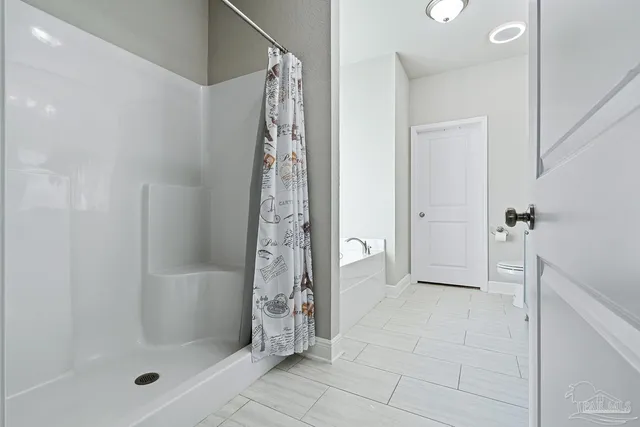 a bathroom with a shower and a sink