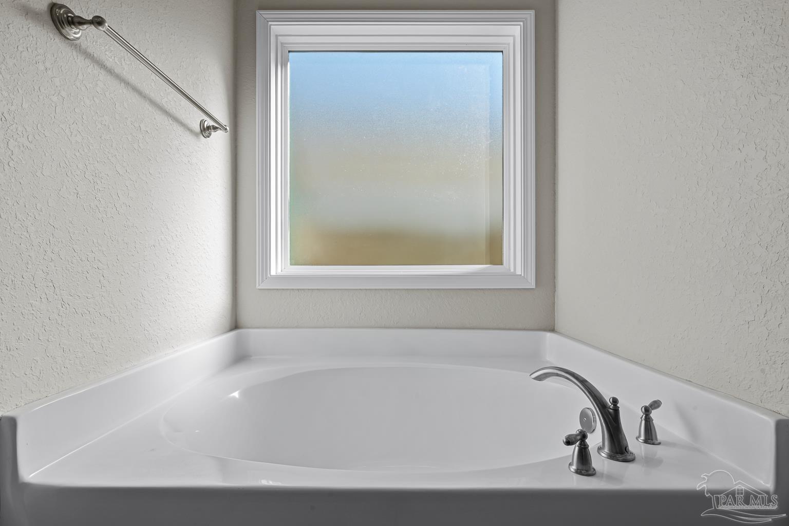 3838 Ranch Road Pace, FL 32571 - Photo 24 of 40 a white bath tub sitting next to a window