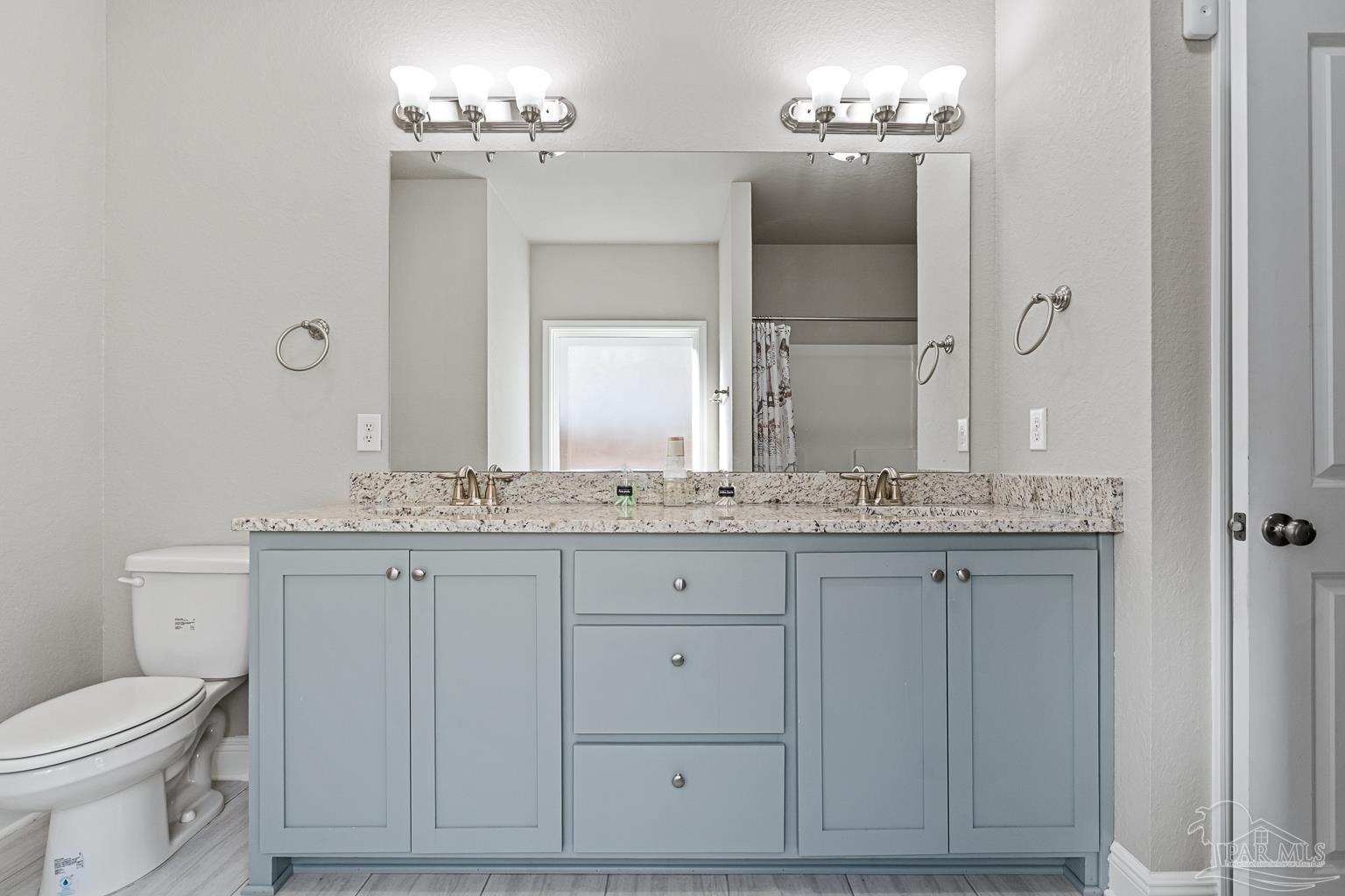 3838 Ranch Road Pace, FL 32571 - Photo 28 of 42 a bathroom with a granite countertop sink and a mirror