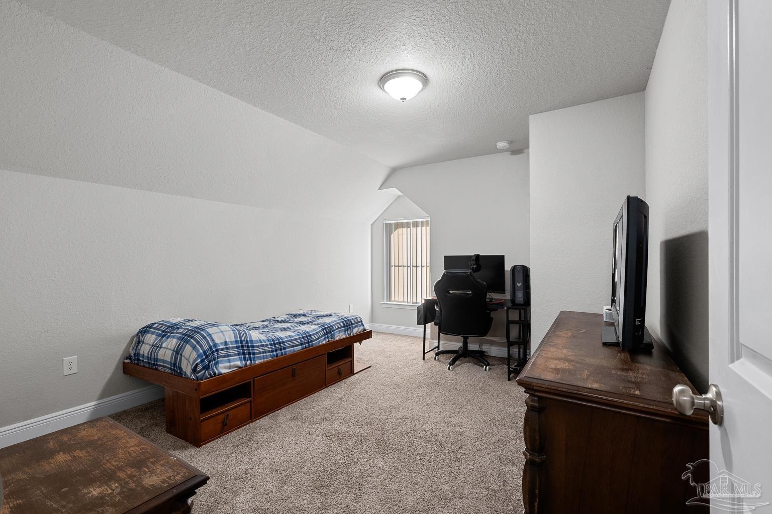 3838 Ranch Road Pace, FL 32571 - Photo 33 of 42 a bedroom with furniture and a flat screen tv