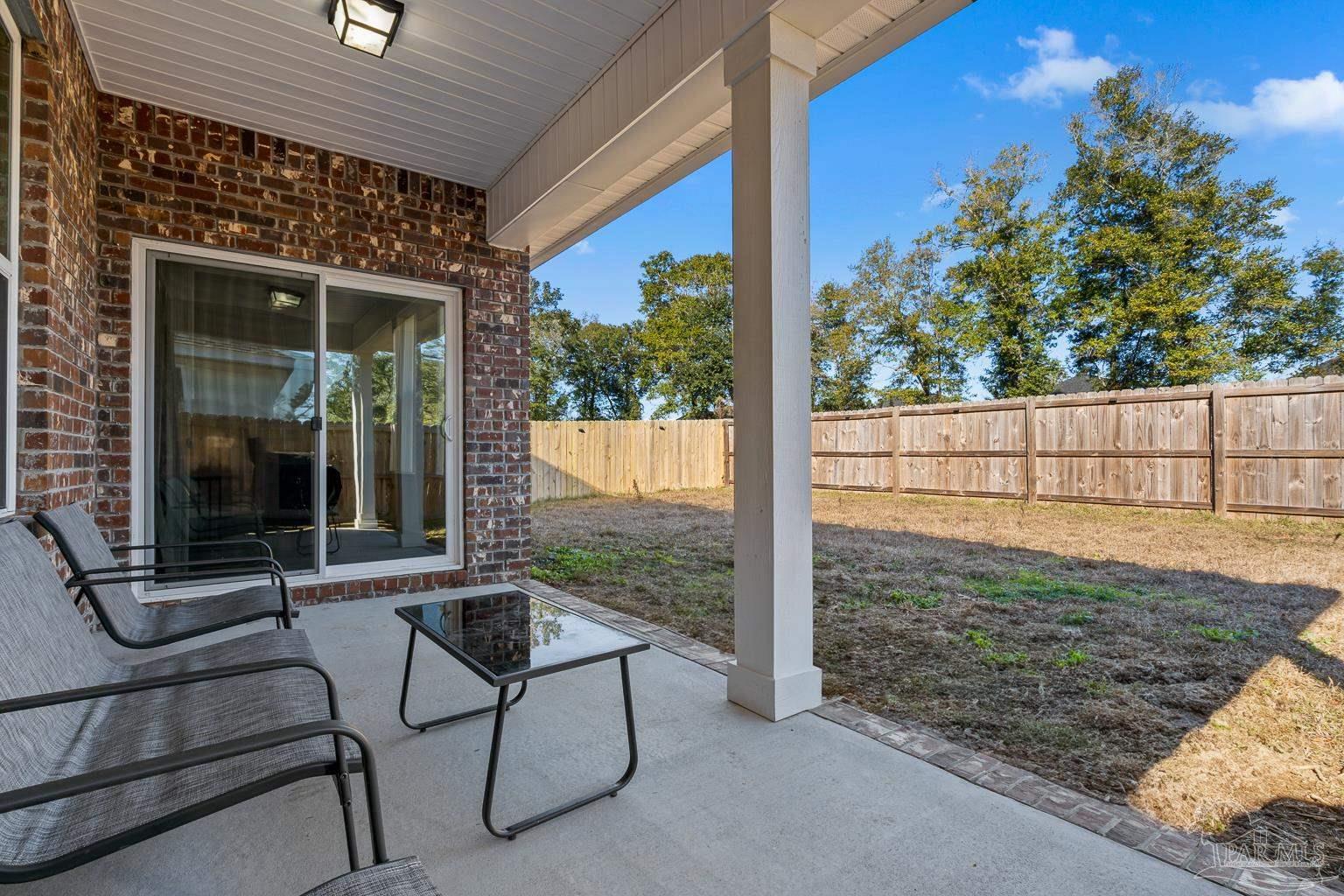 3838 Ranch Road Pace, FL 32571 - Photo 39 of 40 a view of a porch with furniture and floor to ceiling window