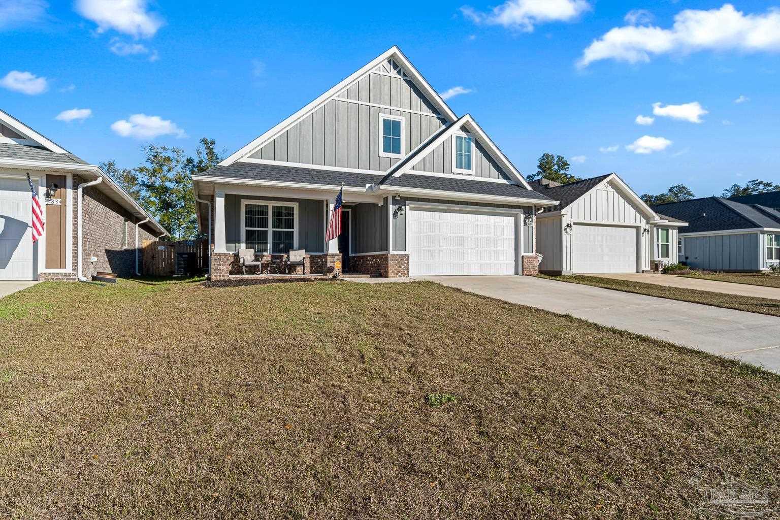 3838 Ranch Road Pace, FL 32571 - Photo 4 of 40 a front view of a house with patio