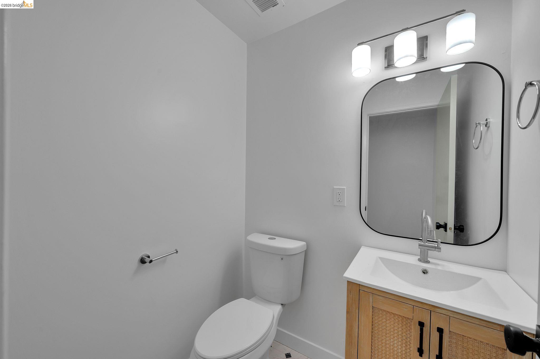 1808 Wildbrook Court, Unit D Concord, CA 94521 - Photo 21 of 47 a bathroom with a toilet sink and mirror