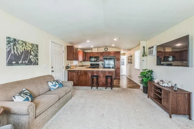 a kitchen with stainless steel appliances granite countertop a refrigerator a stove a sink and a cabinets