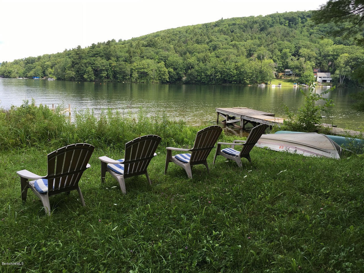 16 Bidwell Road Monterey, MA 01245 - Photo 35 of 40 a view of a lake with a bench and a yard