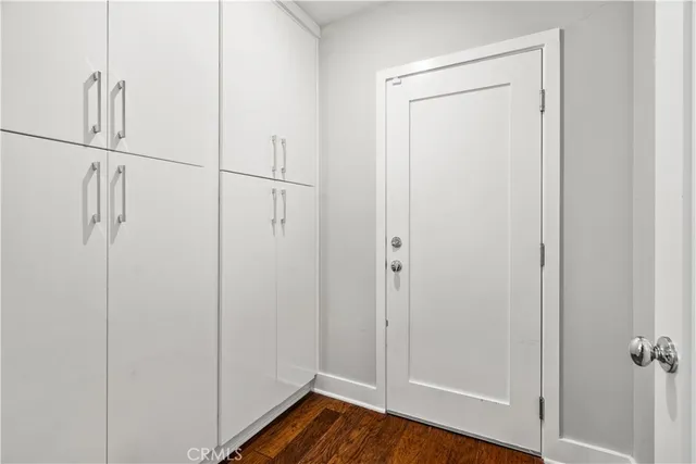 a view of a room with wooden floor