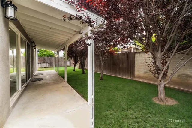 an aerial view of a house with a yard swimming pool and outdoor seating