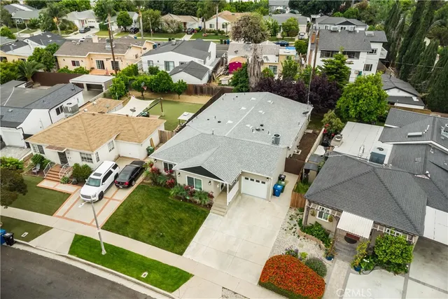 an aerial view of residential houses with outdoor space