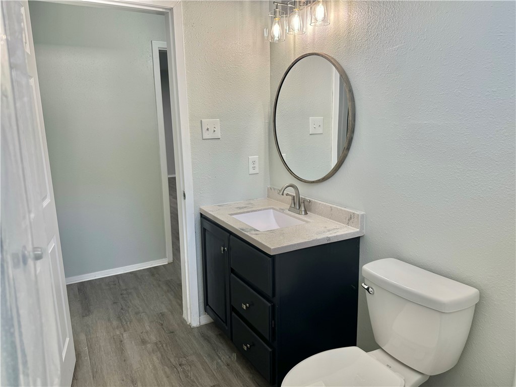 1805 3rd Street Corpus Christi, TX 78404 - Photo 14 of 26 a bathroom with a toilet sink and mirror