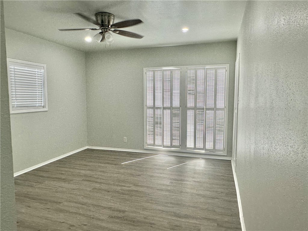 1805 3rd Street Corpus Christi, TX 78404 - Photo 16 of 26 an empty room with wooden floor fan and windows