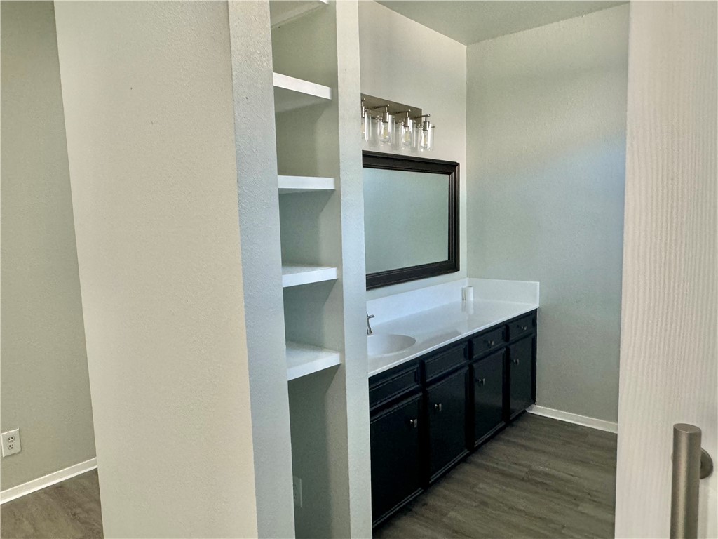 1805 3rd Street Corpus Christi, TX 78404 - Photo 19 of 26 a kitchen with stainless steel appliances cabinets and wooden floor