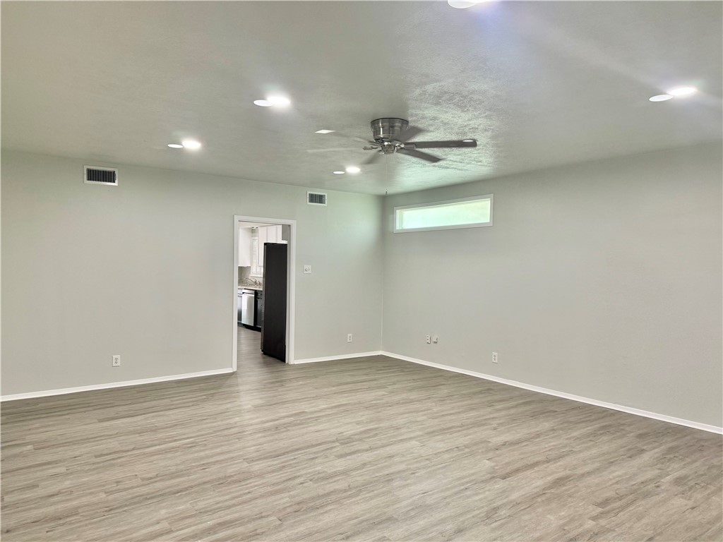 1805 3rd Street Corpus Christi, TX 78404 - Photo 5 of 26 an empty room with wooden floor and windows