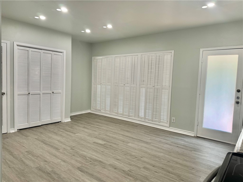 1805 3rd Street Corpus Christi, TX 78404 - Photo 7 of 26 an empty room with wooden floor & windows and bathroom