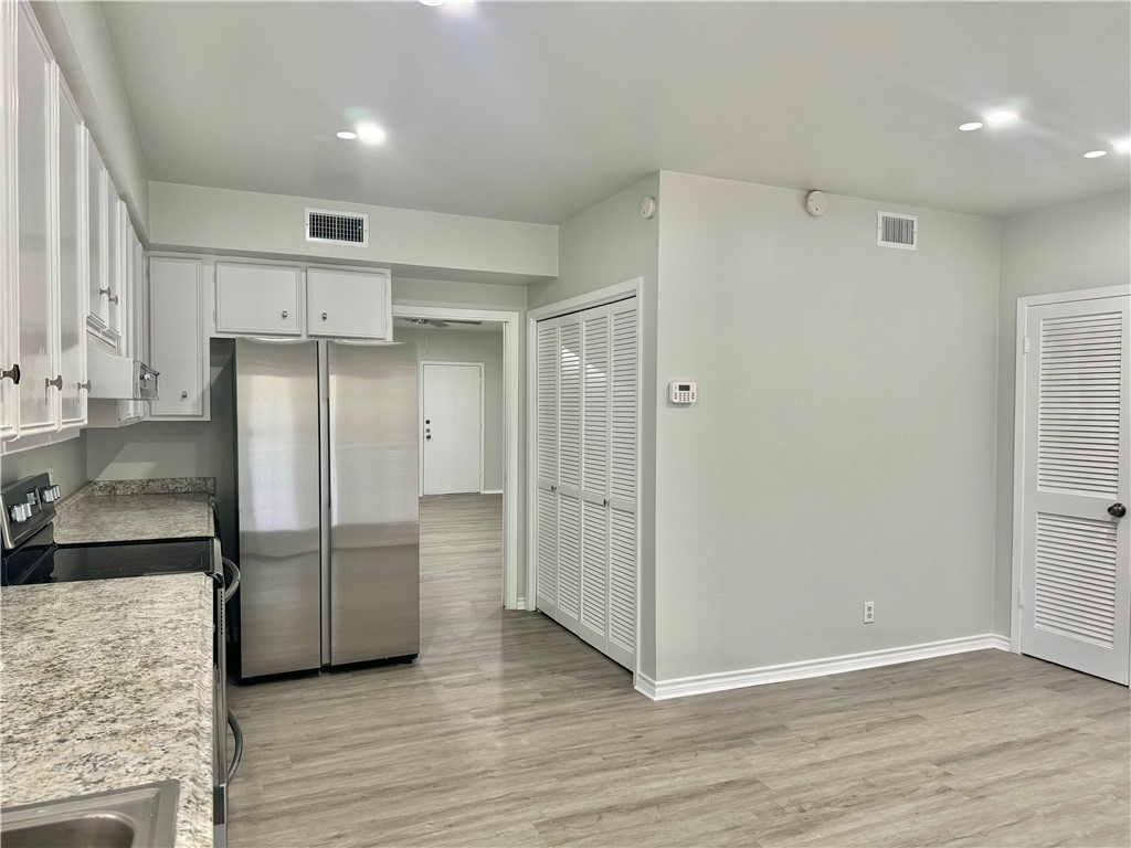 1805 3rd Street Corpus Christi, TX 78404 - Photo 8 of 26 a kitchen with stainless steel appliances granite countertop a refrigerator and a sink