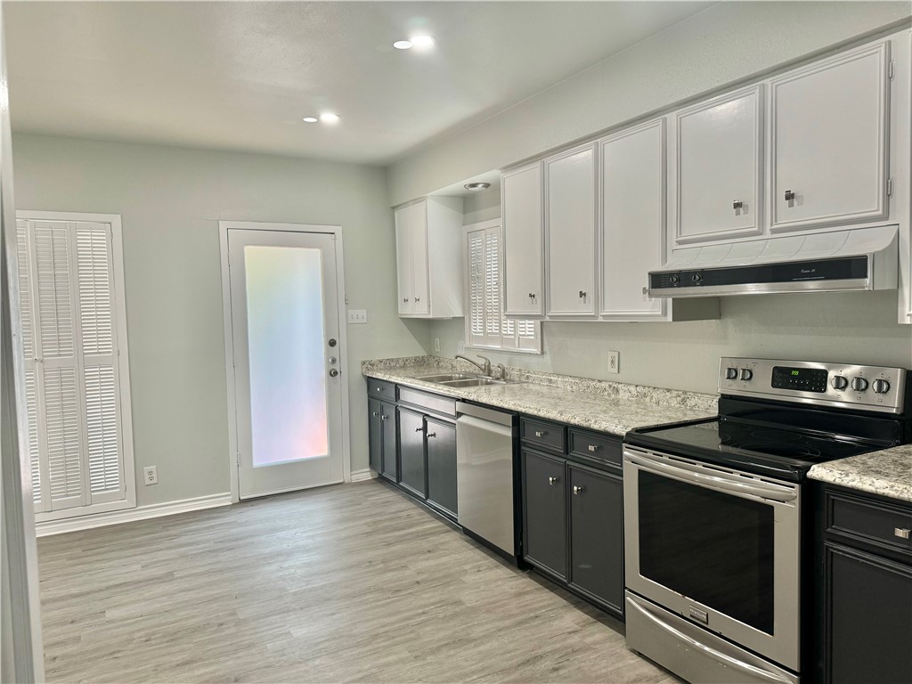 1805 3rd Street Corpus Christi, TX 78404 - Photo 9 of 26 a kitchen with stainless steel appliances granite countertop a stove and a sink