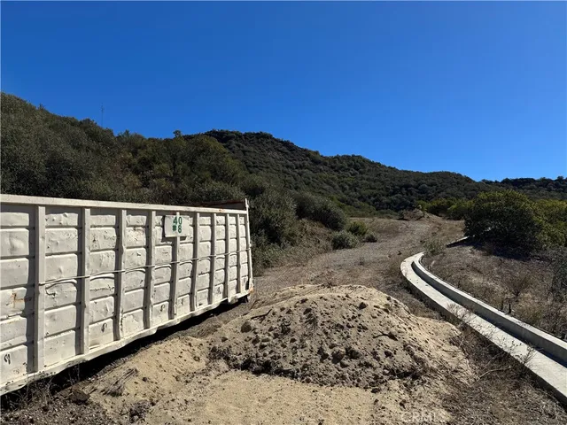 a view of a mountain with a field