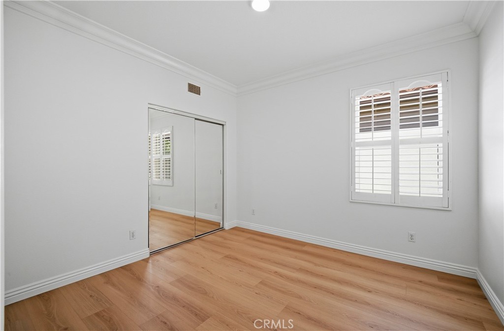 17 Bell Irvine, CA 92620 - Photo 16 of 24 an empty room with wooden floor cabinet and windows