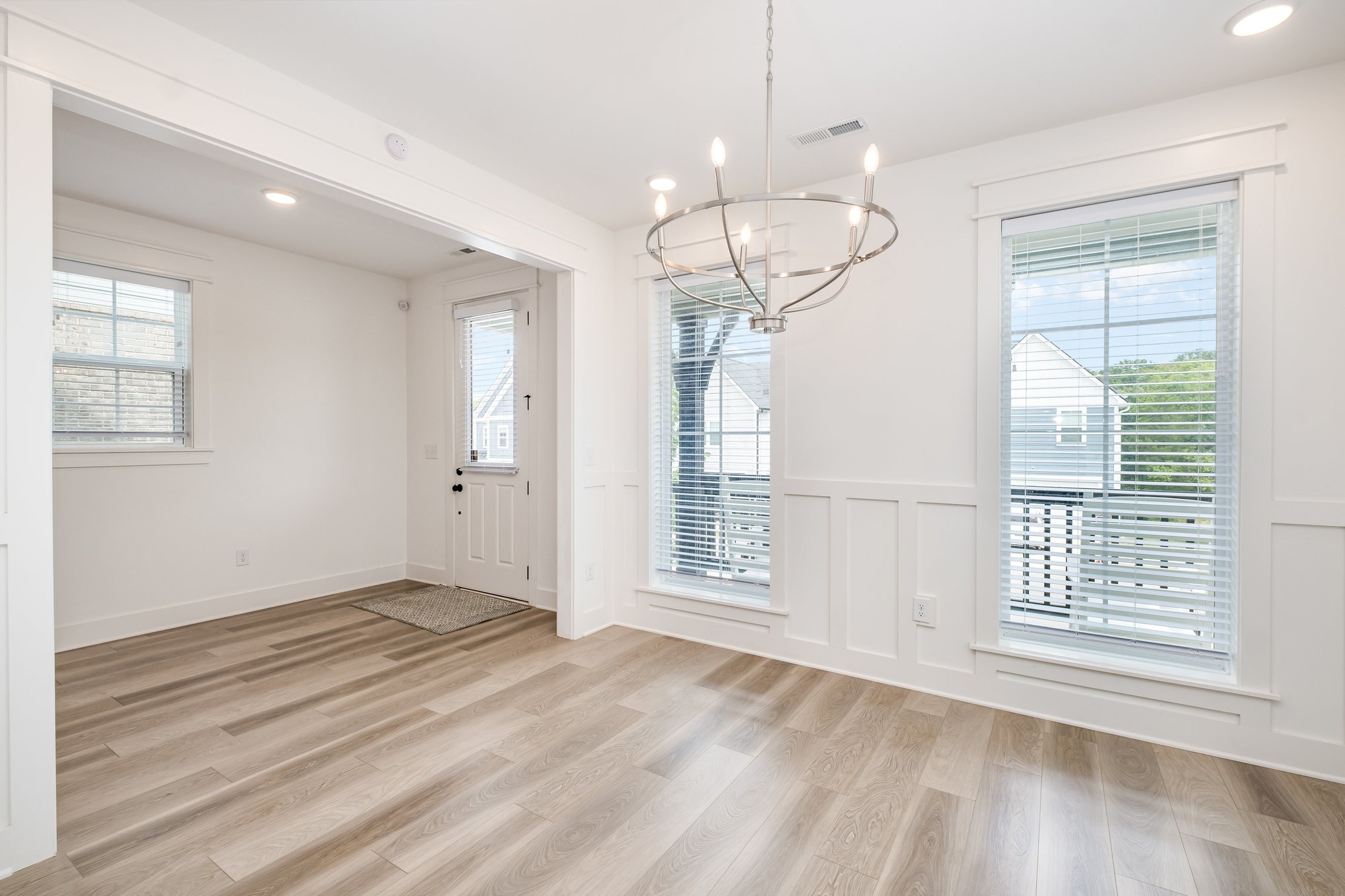 226 Sounder Circle La Vergne, TN 37086 - Photo 4 of 7 an empty room with wooden floor chandelier and windows