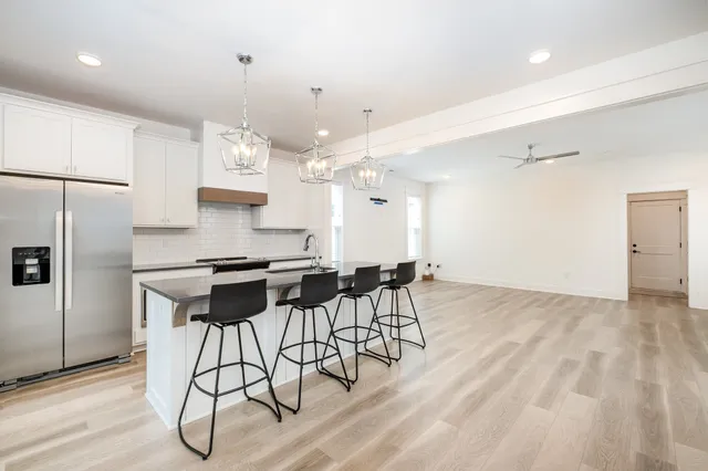 a kitchen with stainless steel appliances kitchen island a chandelier