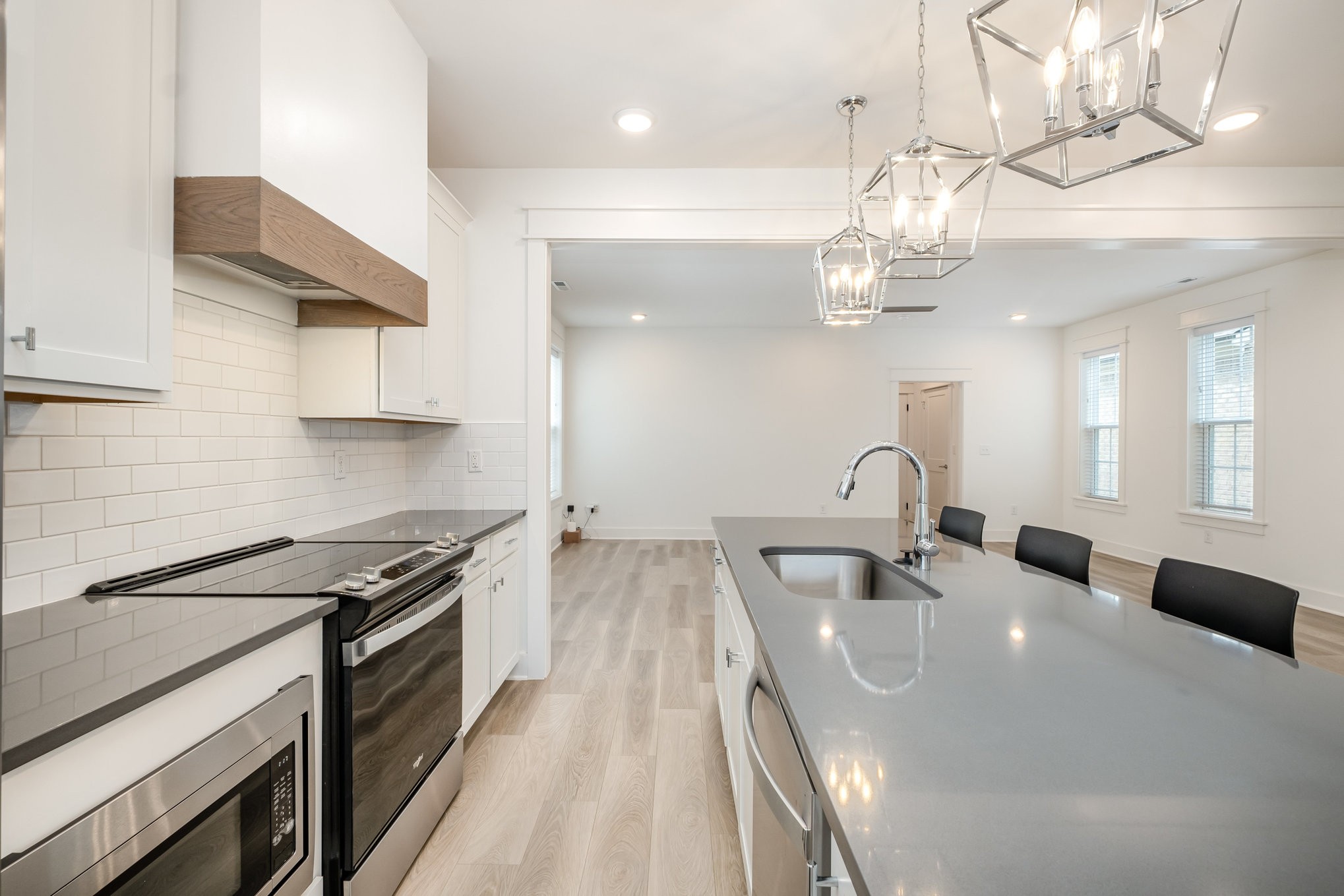 226 Sounder Circle La Vergne, TN 37086 - Photo 7 of 7 a kitchen with stainless steel appliances granite countertop a sink dishwasher a stove a dining table and chairs with wooden floor