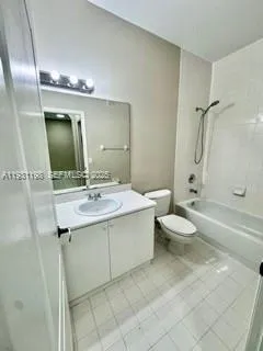 a bathroom with a double vanity sink toilet and shower