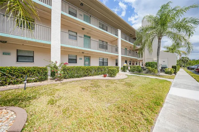 a swimming pool with outdoor seating and yard