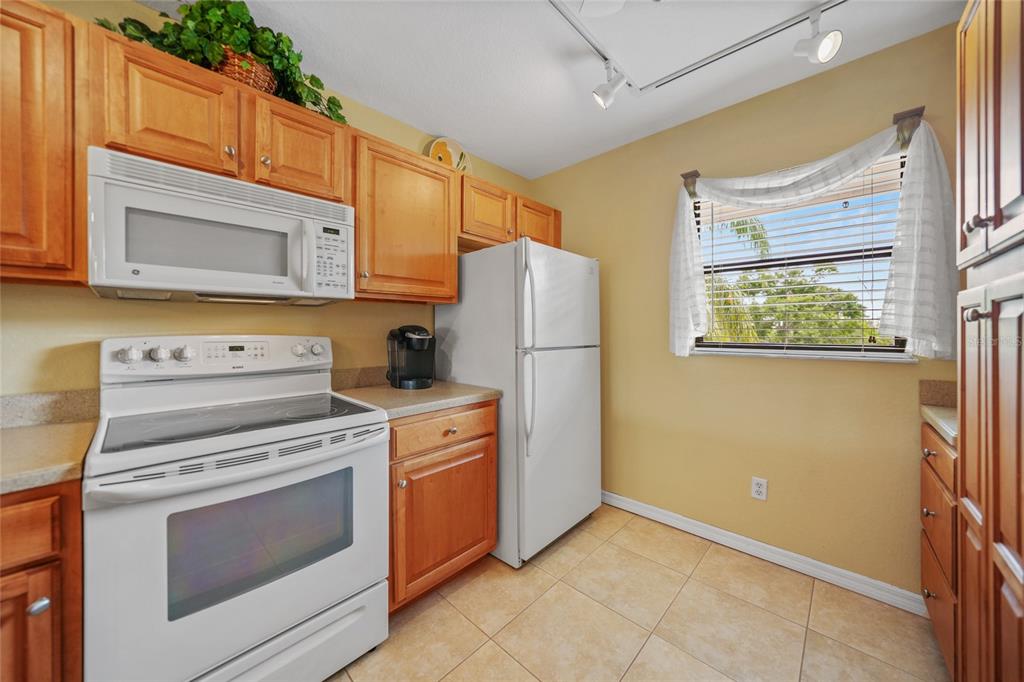 175 Kings Highway, Unit 226 Punta Gorda, FL 33983 - Photo 12 of 41 a kitchen with a stove microwave and refrigerator