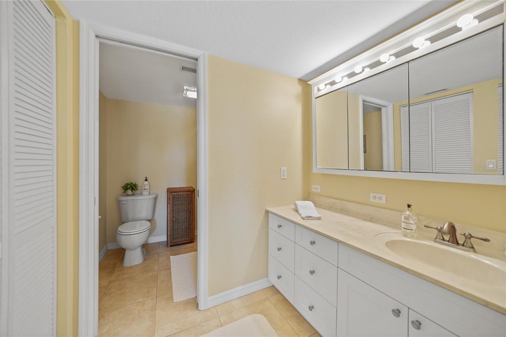 175 Kings Highway, Unit 226 Punta Gorda, FL 33983 - Photo 20 of 41 a bathroom with a granite countertop toilet sink and mirror