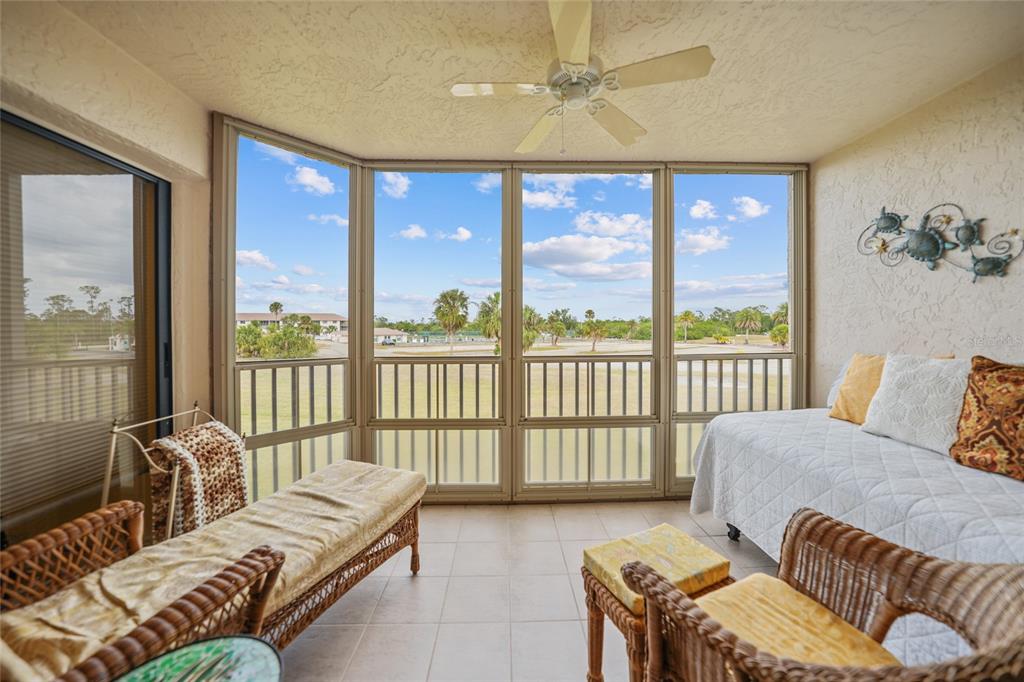 175 Kings Highway, Unit 226 Punta Gorda, FL 33983 - Photo 22 of 41 a living room with furniture and a floor to ceiling window
