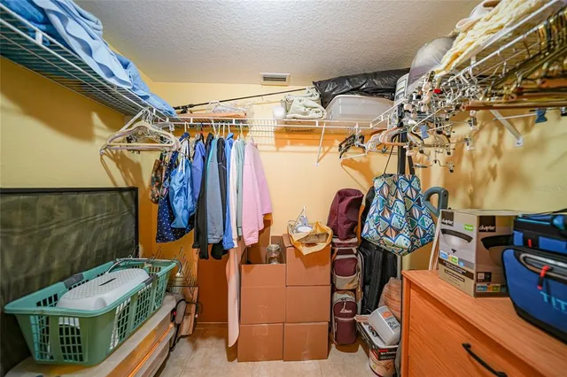a view of walk in closet with clothes