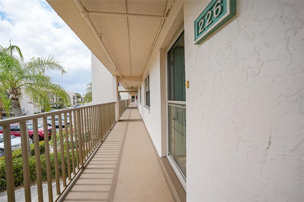 175 Kings Highway, Unit 226 Punta Gorda, FL 33983 - Photo 26 of 41 a view of balcony with wooden floor and stairs