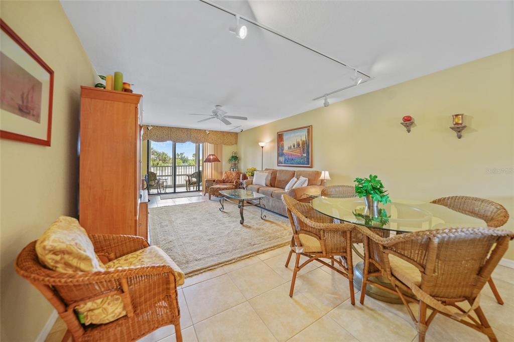 175 Kings Highway, Unit 226 Punta Gorda, FL 33983 - Photo 3 of 41 a living room with furniture and a floor to ceiling window