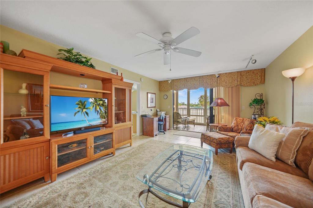 175 Kings Highway, Unit 226 Punta Gorda, FL 33983 - Photo 7 of 41 a living room with furniture and a flat screen tv