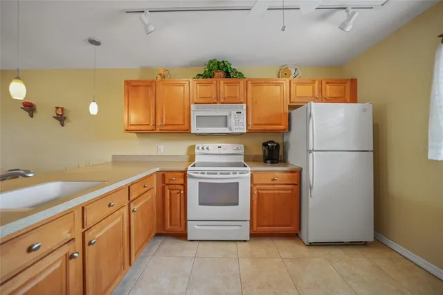 a kitchen with stainless steel appliances a refrigerator sink and cabinets
