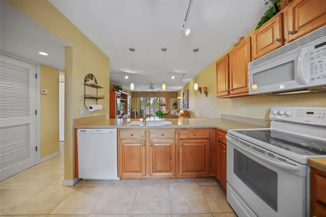 a kitchen with cabinets and white appliances