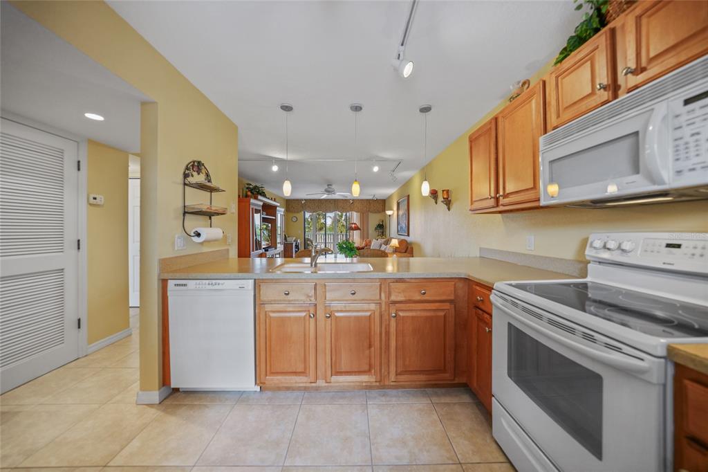 175 Kings Highway, Unit 226 Punta Gorda, FL 33983 - Photo 10 of 41 a kitchen with cabinets and white appliances